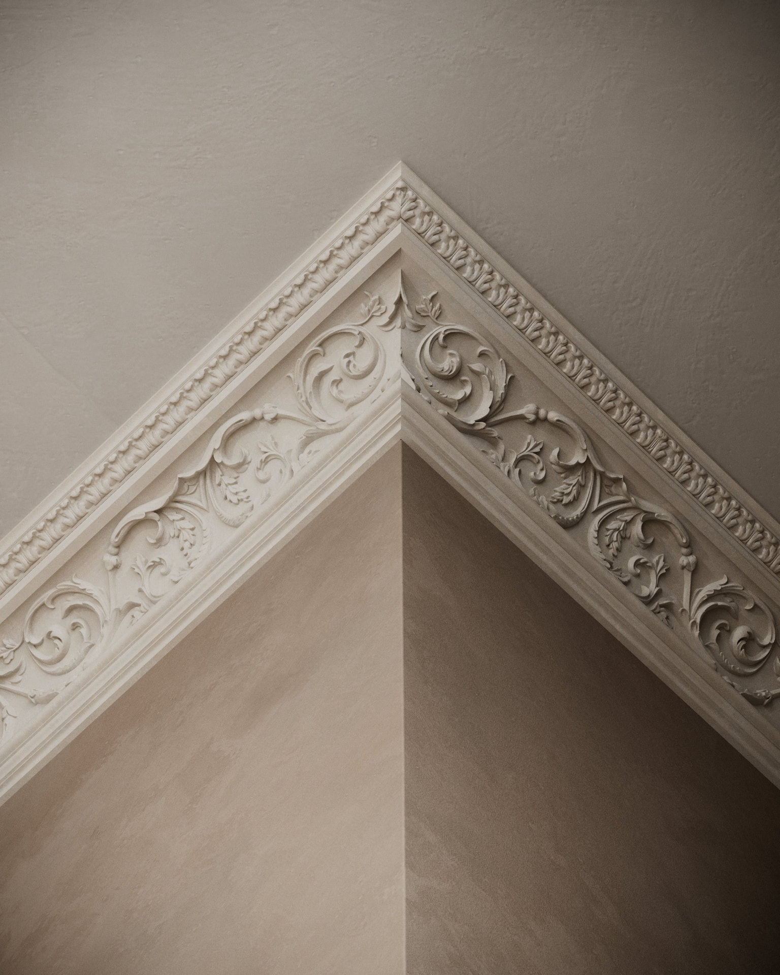 Di Maggiore ornate cornice installed around an interior corner, with side light revealing the relief