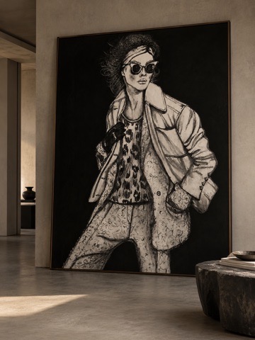 Di Maggiore interior imagery with large monochrome fashion artwork in a softly lit room