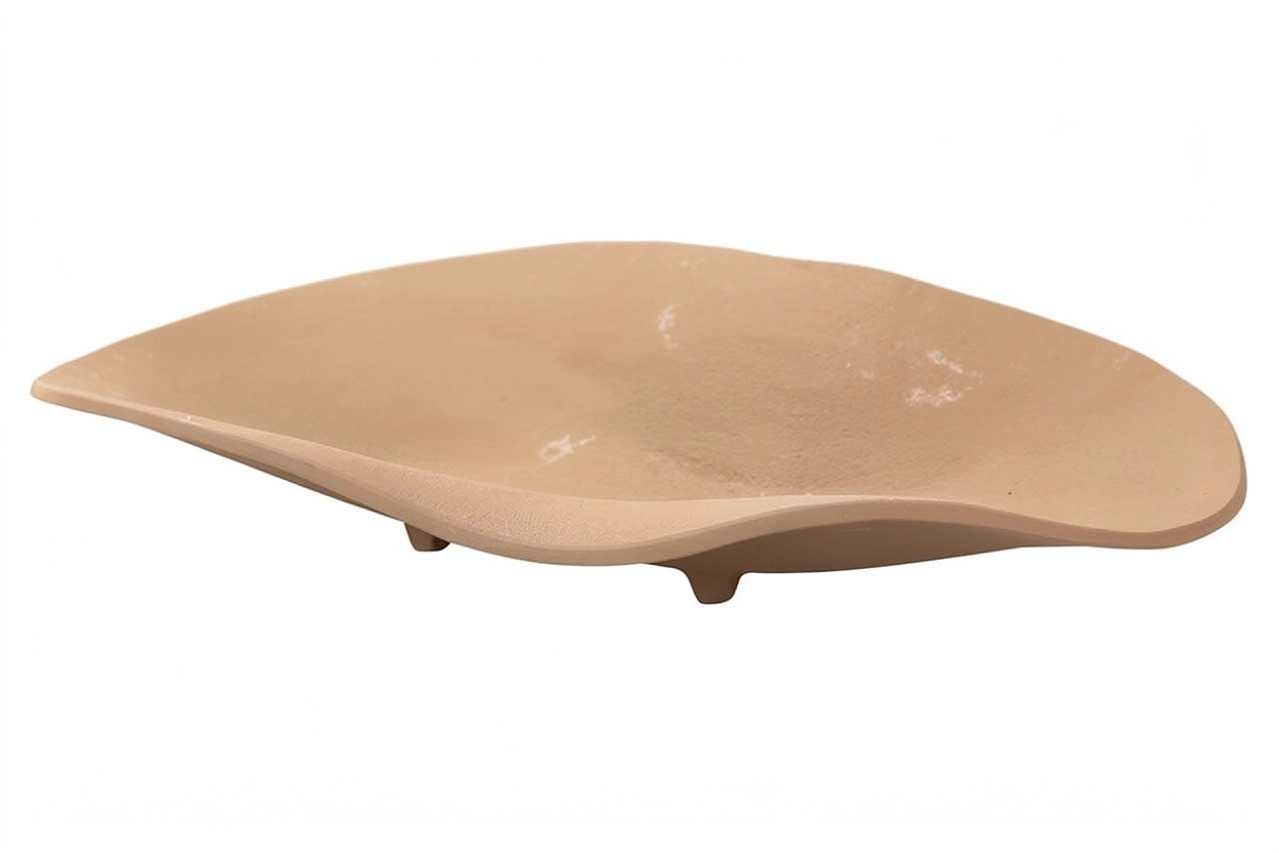 Leaf-shaped beige ceramic serving dish on small feet, ecommerce product photograph
